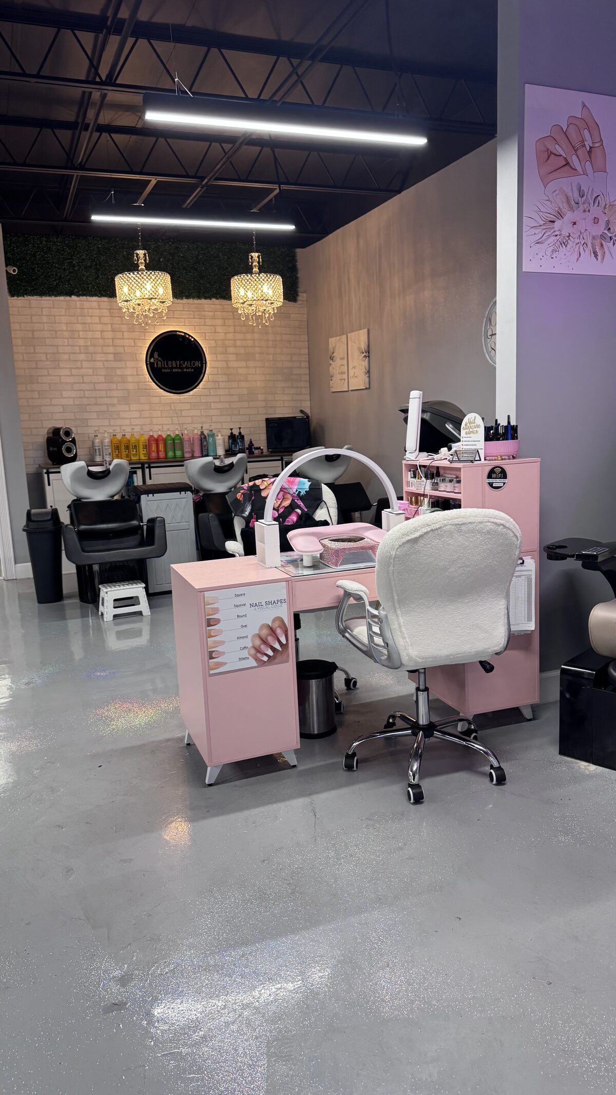 Inside Trilogy Salon: the pink nail station, the shampoo bowls, crystal chandeliers and the round Trilogy Salon sign